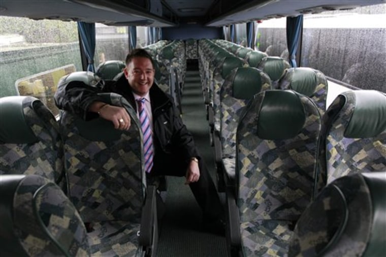 Adrian Morton, the owner of Mortons Travel, poses inside one of his coaches at the company's offices in Little London, England, Thursday, Jan. 6, 2011.